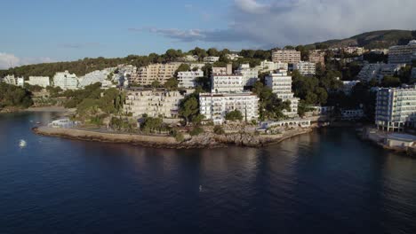 Aerial-View-Flying-Away-From-Oceanfront-Luxury-Hotel-in-Mallorca,-Spain