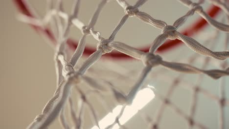 closeup-of-a-net-of-a-basketball-hoop-in-an-indoor-court