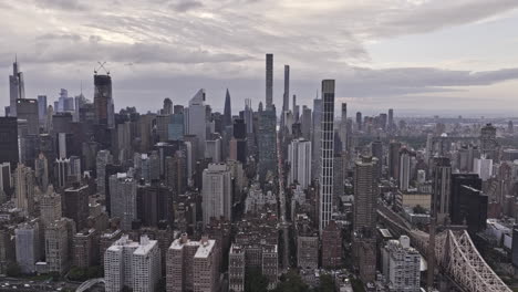 NYC-New-York-Aerial-v330-tracking-shot,-drone-flyover-East-river-capturing-cityscape-of-Midtown-Manhattan-and-Lenox-Hill-neighborhood-against-overcast-sky---Shot-with-Mavic-3-Pro-Cine---September-2023