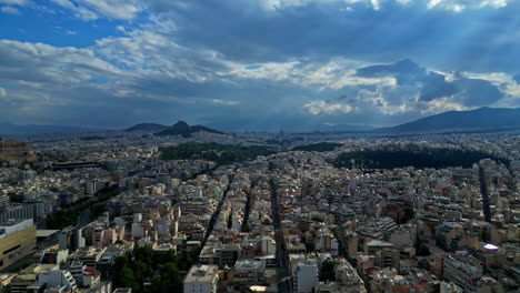Panoramic-drone-shot-of-the-cityscape-of-Athens,-partly,-sunny-day-in-Greece