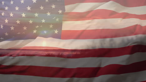 Animation-of-flag-of-usa-over-sunset-by-sea-and-beach-in-summer