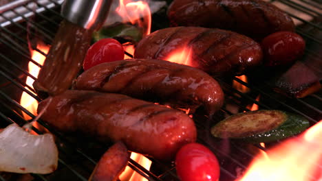 Sausages-being-cooked-on-flaming-barbecue