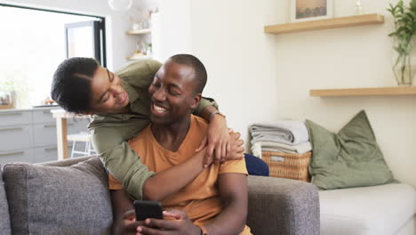 A-diverse-couple-shares-cozy-moment-on-a-sofa