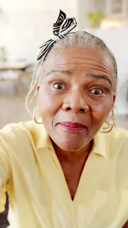 Vertical-video:-African-American-senior-woman-is-smiling-at-camera