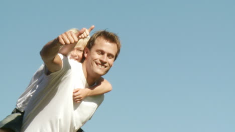 Father-with-son-piggyback-thumbs-up