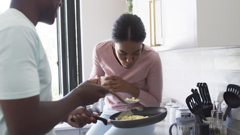 A-young-African-American-couple-enjoys-a-breakfast-together-in-a-kitchen