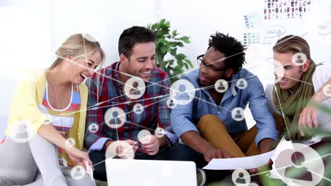 Animation-of-network-of-connections-with-icons-over-diverse-colleagues-discussing-work