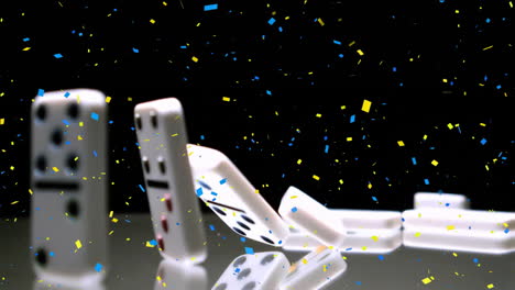 Animation-of-yellow-and-blue-confetti-over-falling-dominoes-on-black-background