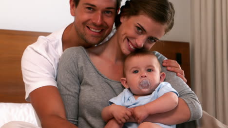 Happy-parents-holding-their-baby-boy