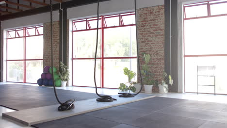 Large-windows-let-sunlight-into-spacious-gym-with-ropes-and-mats