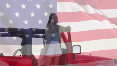 Animation-of-flag-of-usa-over-african-american-woman-talking-on-smartphone