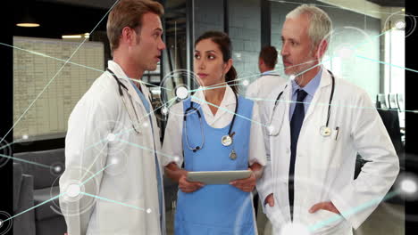 Animation-of-network-over-smiling-caucasian-female-and-male-doctors-using-tablet