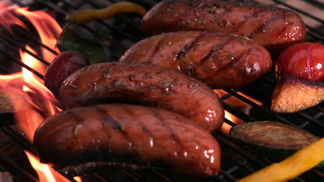 Sausages-being-cooked-on-flaming-barbecue