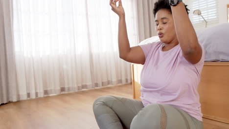 African-American-woman-meditates-in-a-serene-room,-beige-curtains-background-with-copy-space