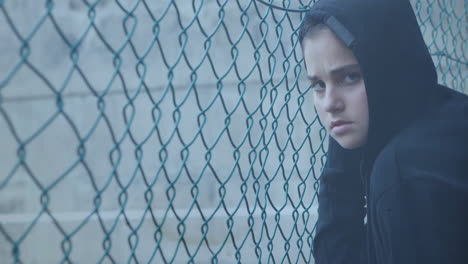 Animation-of-falling-drop-over-sad-caucasian-girl-at-fence