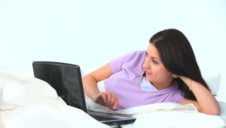 Young-woman-using-her-laptop-and-laughing-