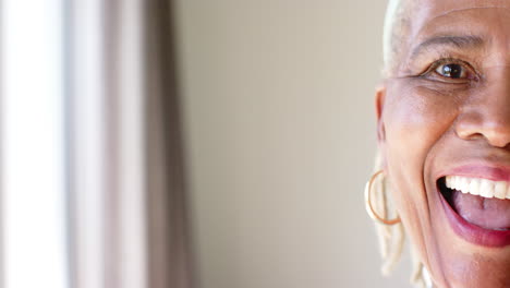 African-American-senior-woman-with-short-gray-hair-and-hoop-earrings-smiling