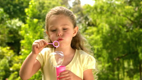 Niña-Soplando-Burbujas-En-El-Parque