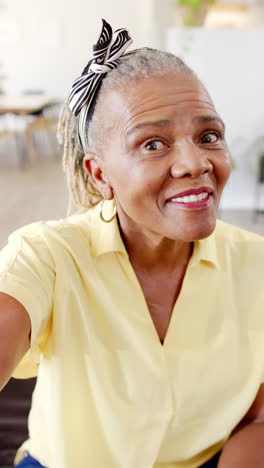 Vertical-video:-A-senior-African-American-woman-with-bright-smile-is-looking-up