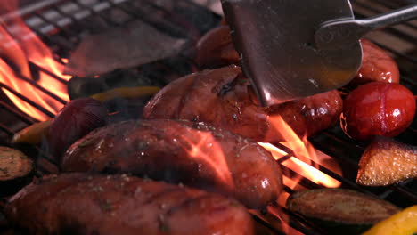 Sausages-being-cooked-on-flaming-barbecue
