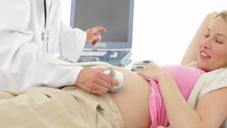 Blonde-pregnant-woman-having-a-sonogram-scan