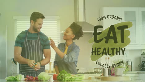 Animation-of-eat-healthy-text-over-diverse-couple-preparing-healthy-meal-in-kitchen