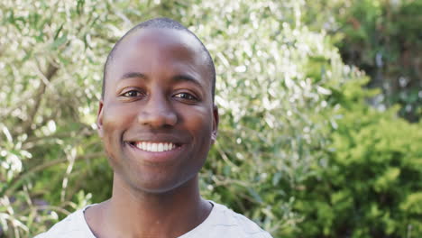 A-young-African-American-man-is-smiling-broadly-outdoors