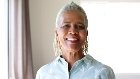 African-American-senior-woman-standing-indoors,-smiling-at-camera