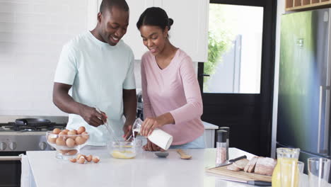 A-diverse-couple-is-preparing-breakfast-together