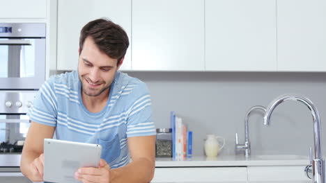 Smiling-man-using-tablet