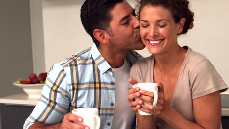 Happy-couple-having-coffee-in-the-kitchen