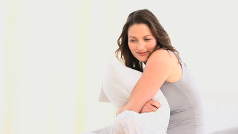 Gorgeous-woman-hugging-her-pillow-
