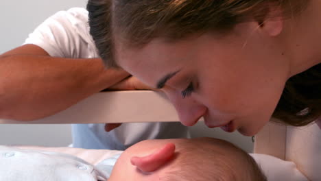 Mother-kissing-her-baby-goodnight