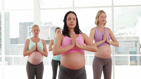 Pregnant-women-doing-yoga-in-fitness-studio