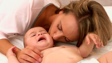 Cute-baby-on-a-bed-with-mother