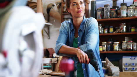 Portrait-of-female-carpenter-standing