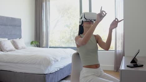 Caucasian-young-woman-wearing-virtual-reality-headset,-making-hand-gestures,-copy-space