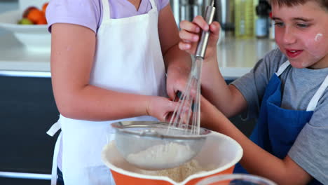 Happy-siblings-making-a-cake-together