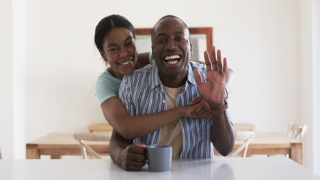 A-young-African-American-couple-shares-a-joyful-moment-at-home