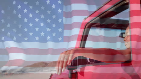 Animation-of-flag-of-usa-over-happy-african-american-woman-in-car-by-beach-in-summer