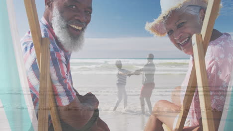 Animation-of-happy-senior-biracial-couple-over-senior-couple-dancing-at-beach