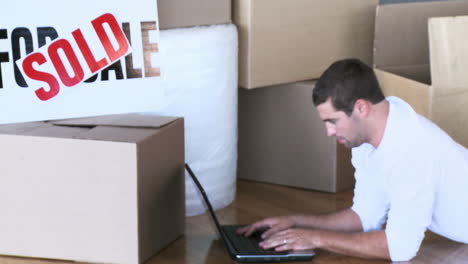 Man-using-the-laptop-during-his-home-move