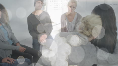 Animation-of-light-spots-over-diverse-people-participating-in-group-therapy