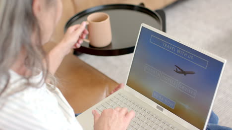 Caucasian-mature-woman-with-gray-hair-looking-at-laptop-screen