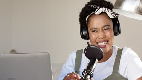African-American-woman-podcasting-with-a-microphone-at-home