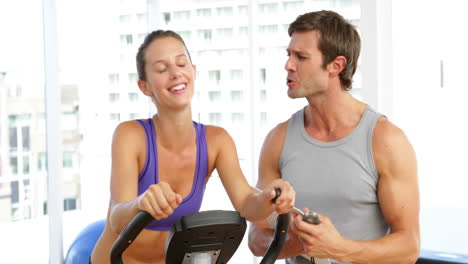 Trainer-timing-his-client-on-exercise-bike