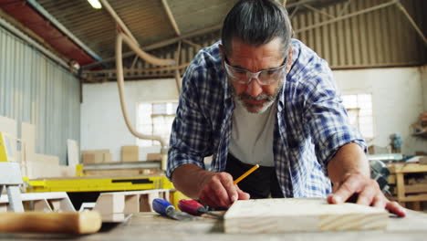 Facing-view-of-carpenter-focused-while-working