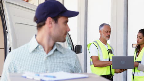 Warehouse-workers-working-together-