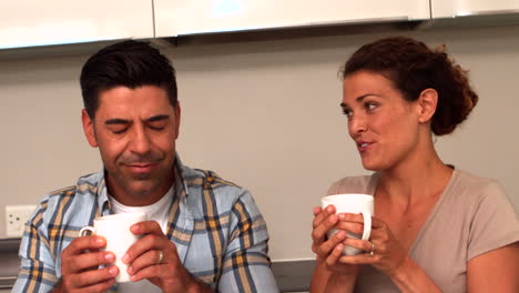 Happy-couple-having-coffee-in-the-kitchen