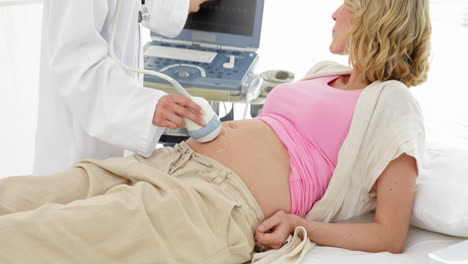 Blonde-pregnant-woman-having-a-sonogram-scan